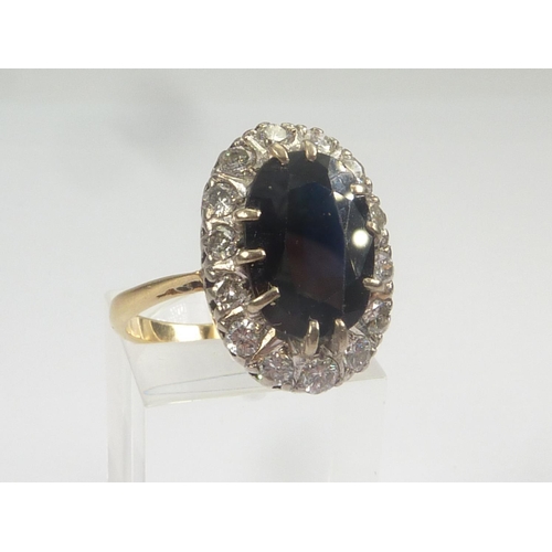 16 - Diamond and sapphire oval cluster ring in 18ct gold. Size 'O'.