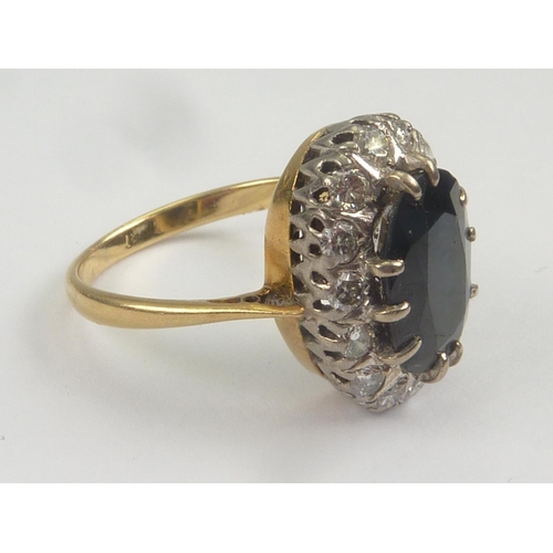 16 - Diamond and sapphire oval cluster ring in 18ct gold. Size 'O'.