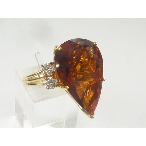 17 - Dress ring with pear shaped citrine flanked by four diamonds in 18ct gold. Size 'O 1/2'.