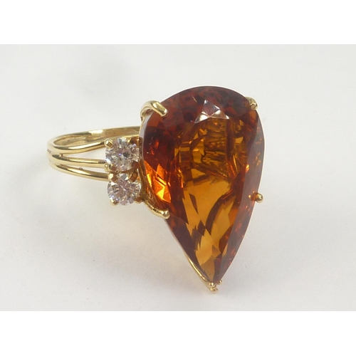 17 - Dress ring with pear shaped citrine flanked by four diamonds in 18ct gold. Size 'O 1/2'.