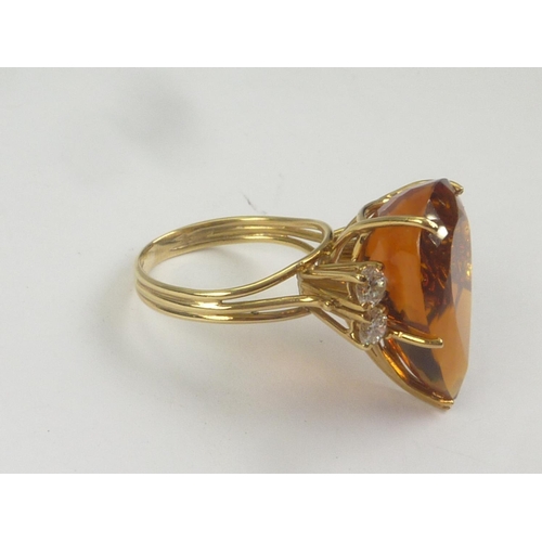 17 - Dress ring with pear shaped citrine flanked by four diamonds in 18ct gold. Size 'O 1/2'.