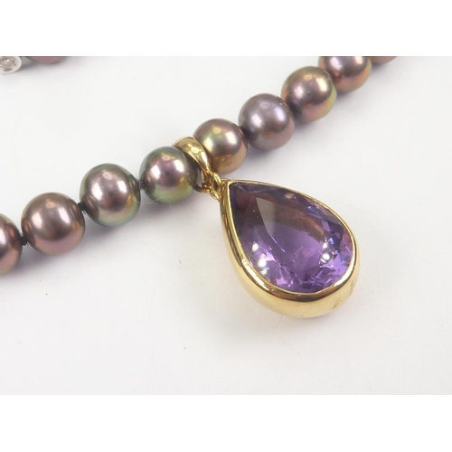 18 - Single row necklace of stained cultured pearls with amethyst drop in 18ct gold, also a pair of ear s... 