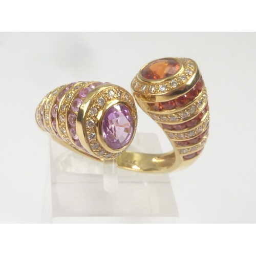 19 - Dress ring with crossover of hessonite garnet and pink tourmaline in 18ct gold. Size 'M' (variable).