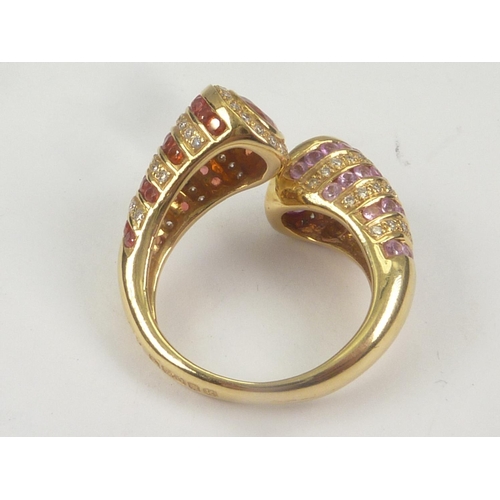 19 - Dress ring with crossover of hessonite garnet and pink tourmaline in 18ct gold. Size 'M' (variable).