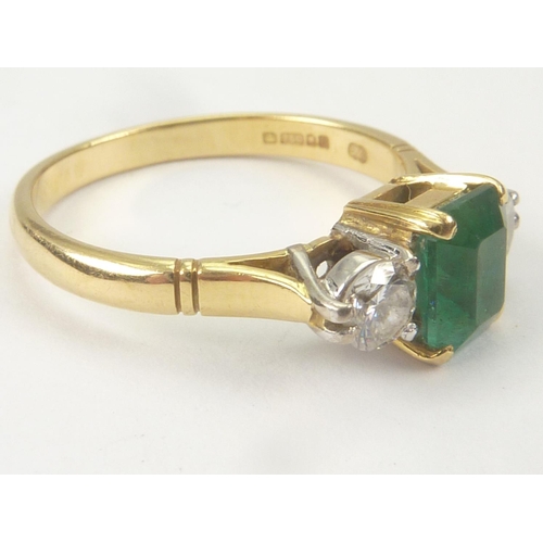 31 - Diamond and emerald three stone ring in 18ct gold, 1978. Size 'L'.