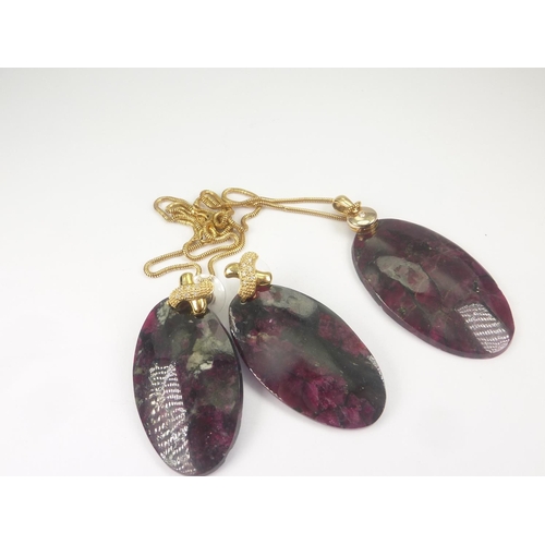 53 - Pair of earrings each with large eudialyte drop on diamond set cross, also a similar pendant.