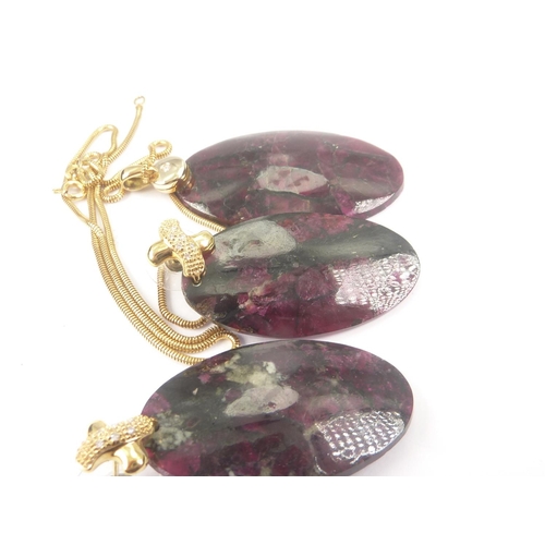 53 - Pair of earrings each with large eudialyte drop on diamond set cross, also a similar pendant.