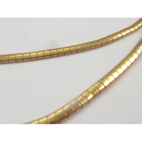 55 - Gold necklace of oval snake pattern, '.750'.