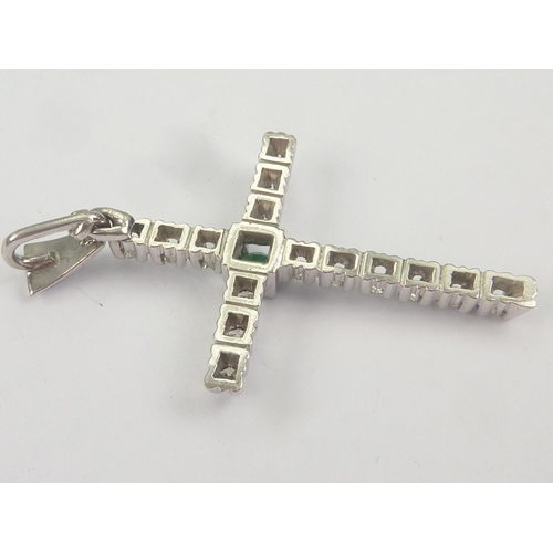 62 - Diamond and emerald cross in white gold, probably 18ct.