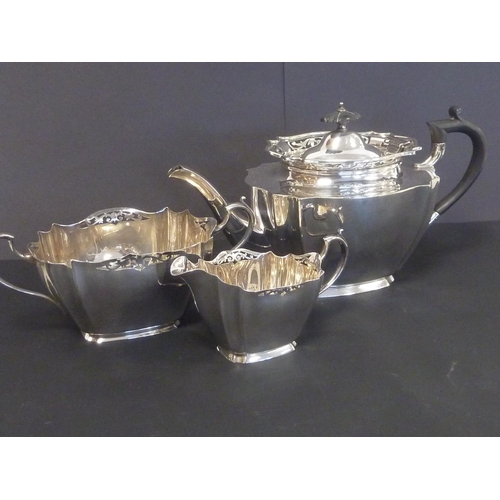 66 - E.p. three piece tea set of polygonal form and another with pierced edges.