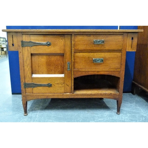 617 - Edwardian oak Arts and Crafts sideboard, the central cupboard flanked by two small drawers over rece... 