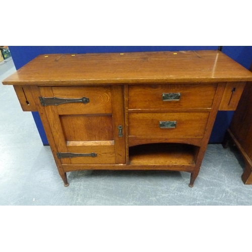 617 - Edwardian oak Arts and Crafts sideboard, the central cupboard flanked by two small drawers over rece... 