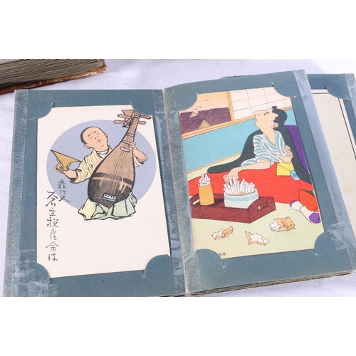 252 - Two albums containing approximately 180 early 20th century Japanese postcards, most are humorous alt... 