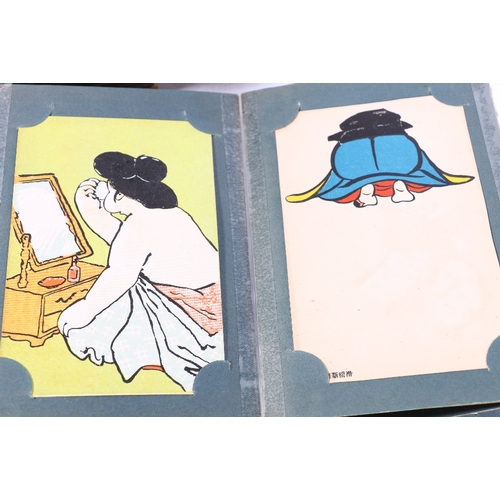 252 - Two albums containing approximately 180 early 20th century Japanese postcards, most are humorous alt... 