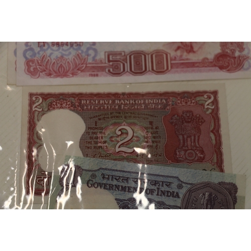 380 - Red folder containing nearly four hundred (400) world banknotes including SOUTH AFRICA, MEXICO, CYPR... 