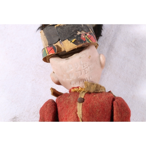 167 - Armand Marseille DEP style doll dressed as a Scottish soldier in kilt and red coat with bearskin, re... 