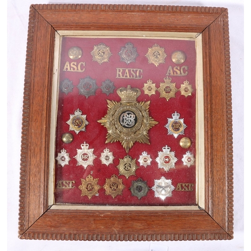 375 - Framed display of approximately 32 Army Service Corps ASC cap badges, collar badges, shoulder titles... 