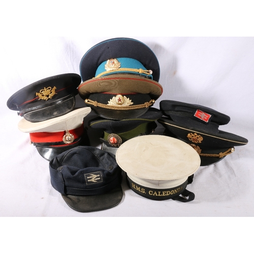 411 - Sailors's cap with HMS Caledonia tally, three Russian peaked caps, two railway caps and three other ... 