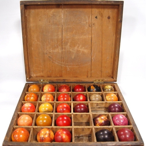 259 - Twenty-seven assorted 19th century billiard balls, some ivory, with box.