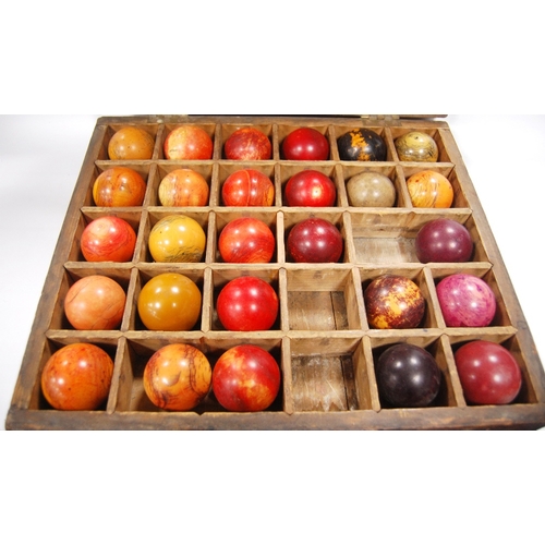 259 - Twenty-seven assorted 19th century billiard balls, some ivory, with box.