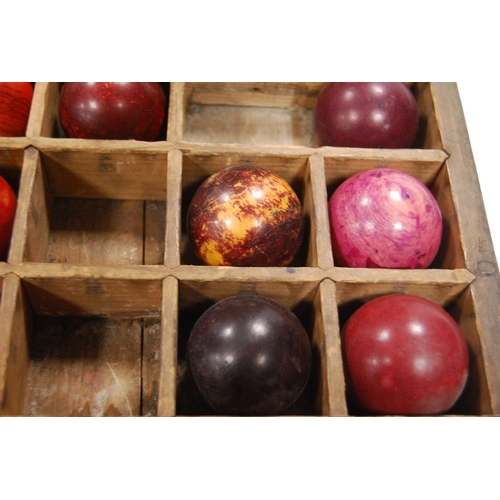 259 - Twenty-seven assorted 19th century billiard balls, some ivory, with box.