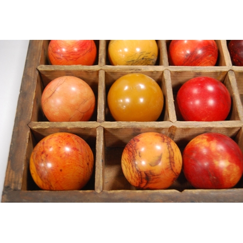 259 - Twenty-seven assorted 19th century billiard balls, some ivory, with box.