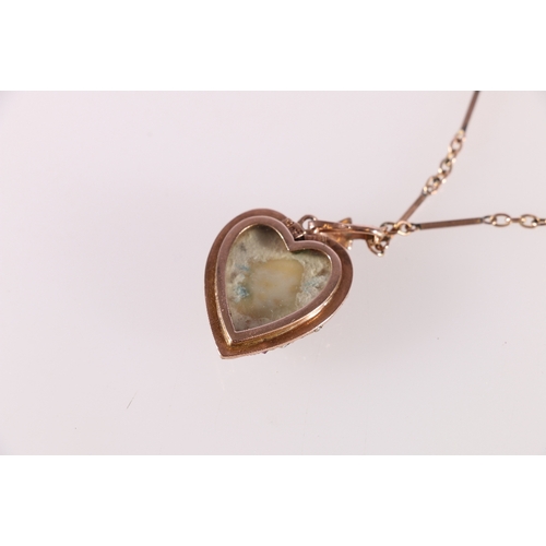 86 - 9ct yellow gold mourning locket pendent of heart shape set with diagonal rows of rubies and pearls u... 