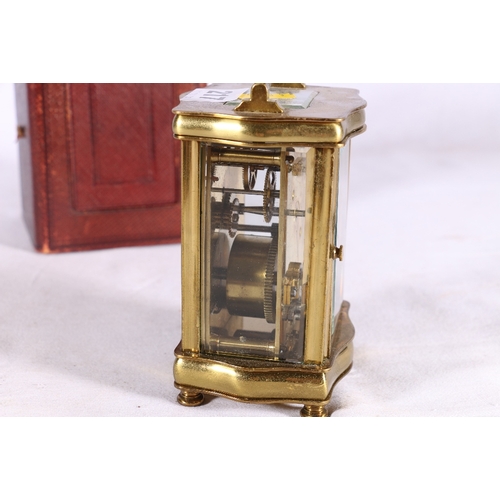 217 - French carriage clock in serpentine case with further leather carrying case, 16cm tall