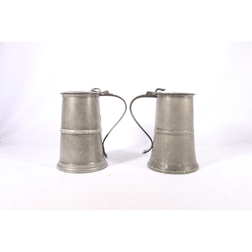 254 - Near pair of pewter communion lidded flagons or tankards, one stamped to interior 