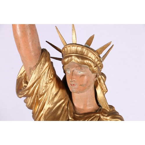 230 - Metal table light in the form of the statue of liberty with opalescent flame shade, 100cm tall