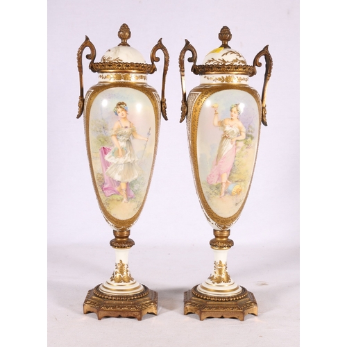 240 - Pair of French Limoges Serves style urns and covers with ormolu style mounts, the vignettes depictin... 