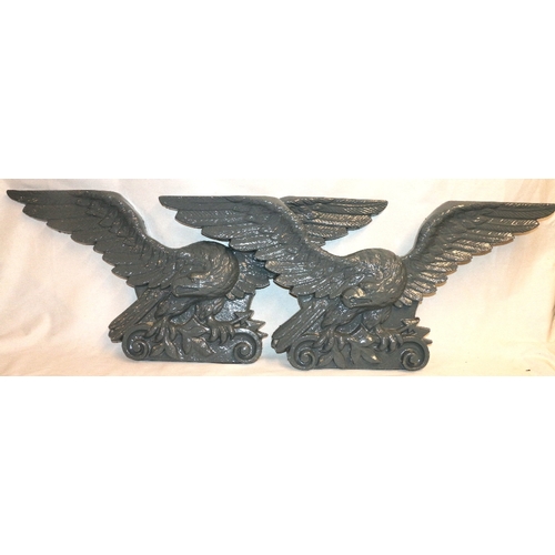 467 - Pair of 19th century cast iron eagle plaques, 95cm wide and 41cm high.