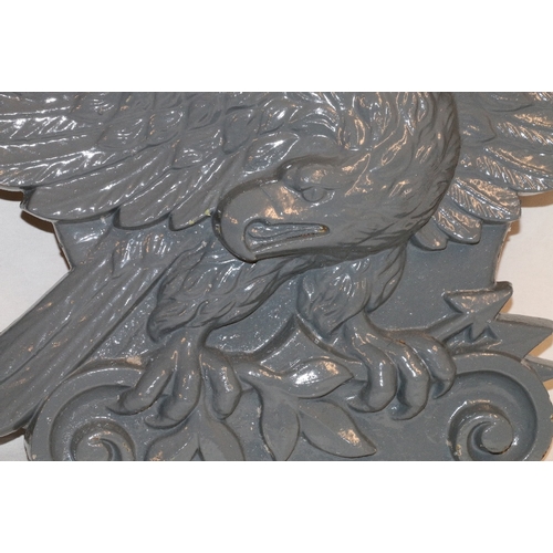 467 - Pair of 19th century cast iron eagle plaques, 95cm wide and 41cm high.