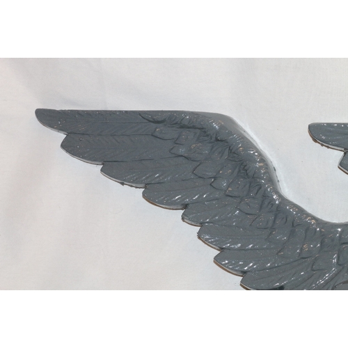 467 - Pair of 19th century cast iron eagle plaques, 95cm wide and 41cm high.