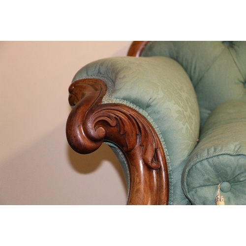 490 - Victorian mahogany framed scroll arm sofa upholstered in green floral fabric with button back raised... 