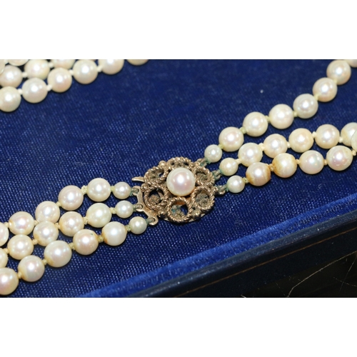 102 - Triple strand of cultured pearls with 9ct yellow gold closure within Mikimoto box.