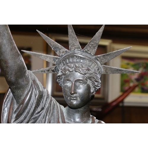 231 - Metal table light in the form of the statue of liberty, 68cm tall