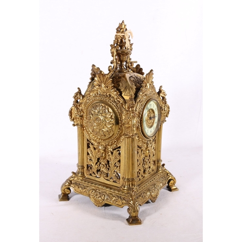 133E - 19th century gilded brass mantle clock with pierced sides having urn finial, 34cm tall