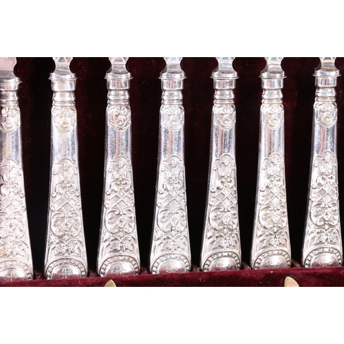 134 - Set of twelve Victorian silver plated fruit knives and forks with engraved blades and repousse handl... 