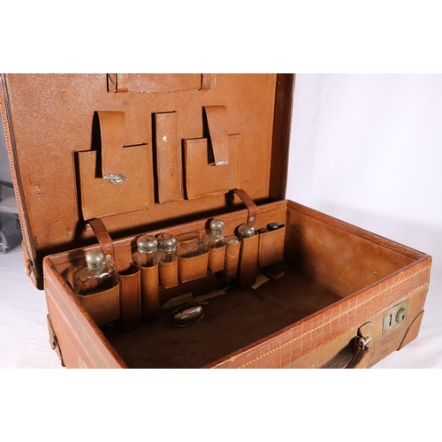 135 - Art Deco style leather crocodile skin effect travel case with silver plated toilet bottles to the in... 