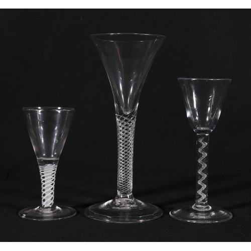 220 - Three antique drinking glasses with air twist and opaque twist stems, the largest with trumpet shape... 