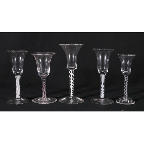 222 - Five antique glass drinking glasses with inverted bell shaped bowls raised on air twist and opaque t... 