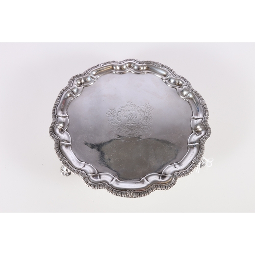 24 - George II silver salver or waiter with feathered pie crust border rim raised on three hoof feet by P... 