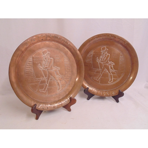 158A - Pair of Johnnie Walker whisky advertising Arts and Crafts style copper trays, 34cm diameter