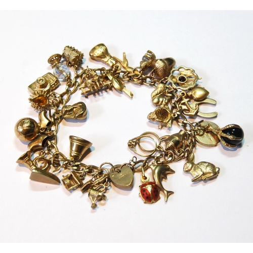 128 - 9ct gold bracelet with various charms, 38.5g gross.