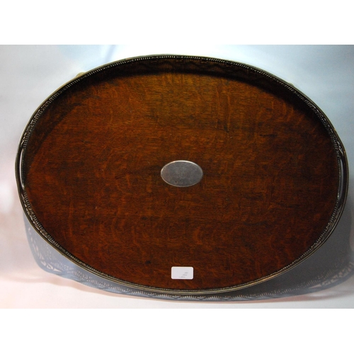 137 - EP oval tray with pierced vertical gallery and silver escutcheon, Birmingham 1910, 57cm.