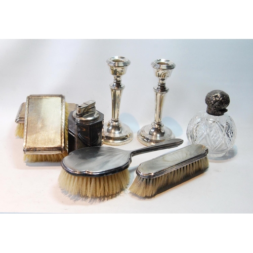 139 - Pair of table candlesticks, loaded, four brushes, a scent bottle and a mounted cigarette lighter.   ... 