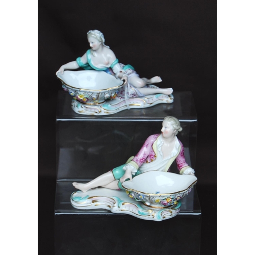 157 - Pair of Meissen sweetmeat dishes in the form of reclining male and female figures in 18th century dr... 