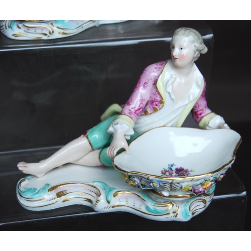 157 - Pair of Meissen sweetmeat dishes in the form of reclining male and female figures in 18th century dr... 