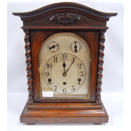 159 - Oak cased mantel clock with arched pediment over etched arched face, Roman numerals, flanked by barl... 